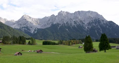 Scenic landscape of fields and mountains at Garmisch-Partenkirchen in Germany Видео 278131033