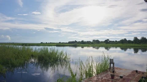 Scenic landscape of Okavango Delta in Namibia with vast river reflecting blue sk Stock Footage 333331587