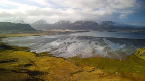 Scenic landscape of river bed and shallow water bay in eastern Iceland. wit.. Видео 322208842