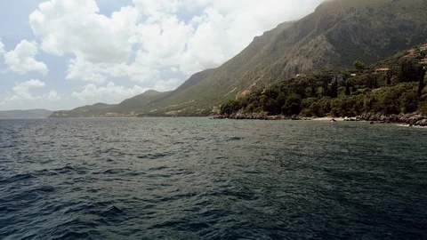 Scenic landscape. Rock cliffs surrounded by clear Mediterranean sea. Greece. 4K Stock Footage 122670958