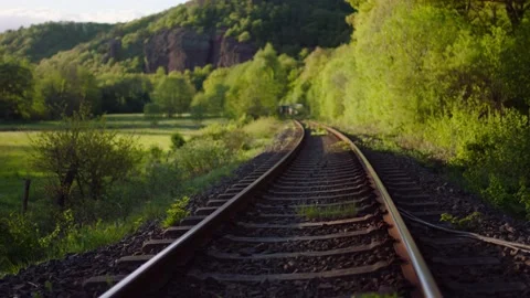 Scenic landscape Rocks Tilt empty rail tracks sunset Stockbeeldmateriaal 232020272