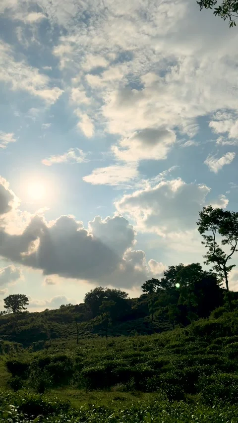 Scenic landscape with sunlit clouds and lush greenery under a vibrant blue .. Stock-Footage 338414651