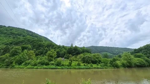 Scenic landscape view from a moving car or train window showing a calm river Vídeo Stock 346181266