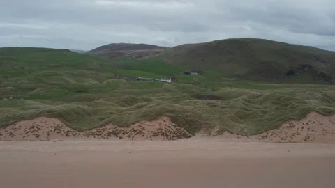 Scenic landscape view of rolling dunes and hills near the coastline in Donegal Stock Footage 310240396
