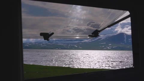 Scenic mountain lake view from campervan window Vidéo 340262418