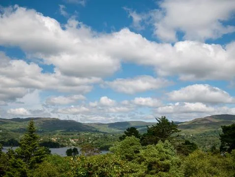 Scenic mountain landscape with clouds over lake Stock Photos