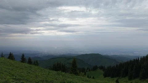 Scenic mountain landscape with rolling hills and cloudy sky over city view Vídeos de archivo 340393641