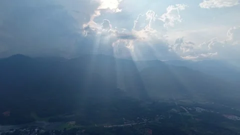 Scenic mountain landscape with sun rays piercing through clouded sky Video stock 339857539