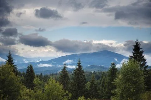Scenic mountain landscape under cloudy sky Stock Photos
