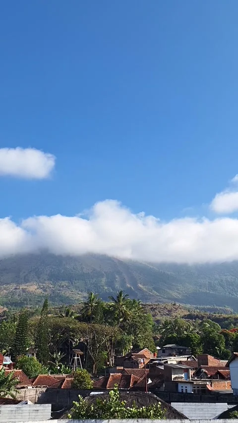 Scenic Mountain Peak With White Clouds and Village Vídeos de archivo 340804275