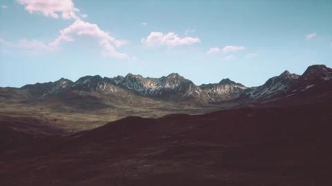 A scenic mountain range with billowing clouds in the sky Stock Illustration