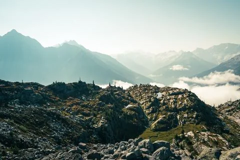 Scenic mountain range view with clouds filling the valleys in the distance. Stock Photos