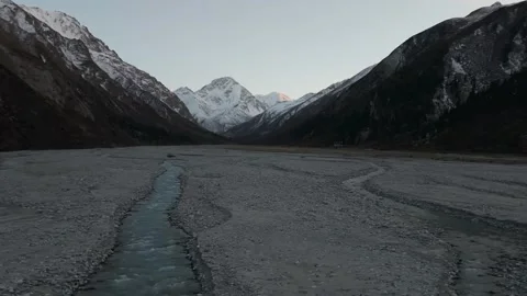 Scenic mountain river flows through rocky valley, camera pans across landscape Video stock 321449340