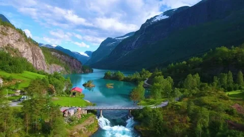 Scenic mountain river with suspension bridge and lush greenery Stock Footage 333397780