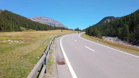 Scenic mountain road winding through a green alpine valley of Swiss national 動画素材 345166974