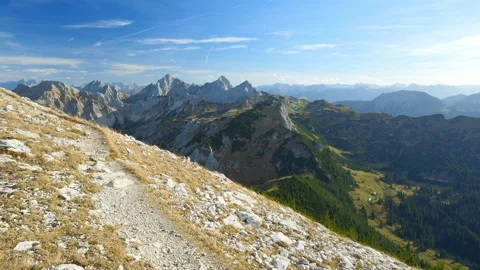 Scenic Mountain Trail on a Crisp Fall Day Near Enge Valley with Distant Peaks Stock Footage 309001946