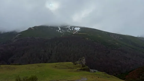 Scenic mountain valley with forests and snowy peaks in northern Spain Видео 339217138