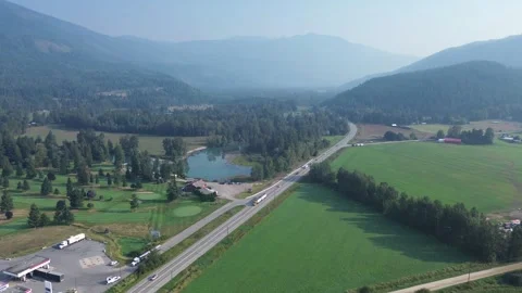 Scenic Mountain Valley with Highway, Lake, and Golf Course Stock Footage 318817618