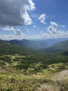 Scenic mountain valley under dramatic summer clouds Stock Photos