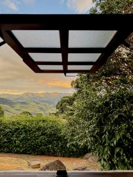 Scenic Mountain View Framed by Rustic Roof Stock Photos