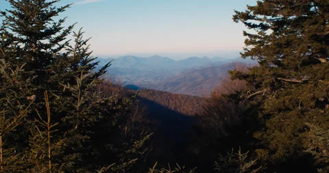 Scenic Mountain View framed by trees in a forest in 4k Stockbeeldmateriaal 144431390