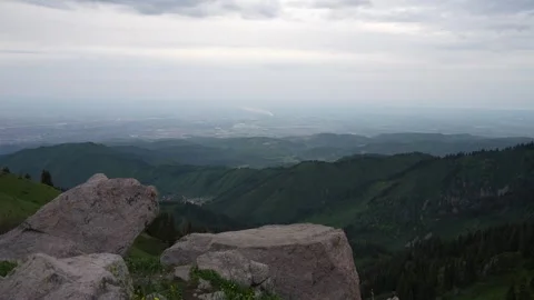 Scenic mountain view with rocky foreground and expansive green hills beyond Stock Footage 340392170