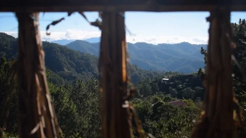 Scenic mountain view thru a bundled dried grass in a window type Stock Footage 102251480