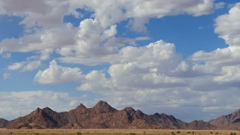 Scenic Namibia - moving clouds and dust over mountains of the Namib desert Stock Footage
