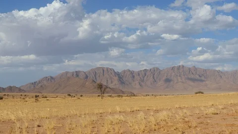 Scenic Namibia - moving clouds and dust over mountains of the Namib desert Stock Footage 107260930