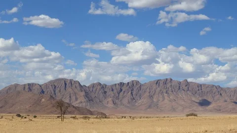 Scenic Namibia - moving clouds and dust over the mountains of the Namib desert Stock Footage 107261090