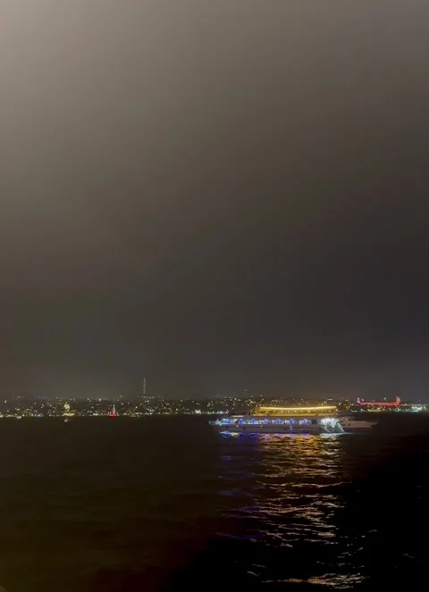 Scenic Nighttime Harbor with Lighted Vessel Stock Footage 304885046