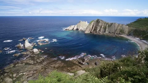 Scenic ocean bay with rocky cliffs and pristine beach Видео 336111231