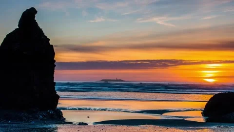 Scenic ocean beach sunset with rock formations wide shot Stock Footage 342396147