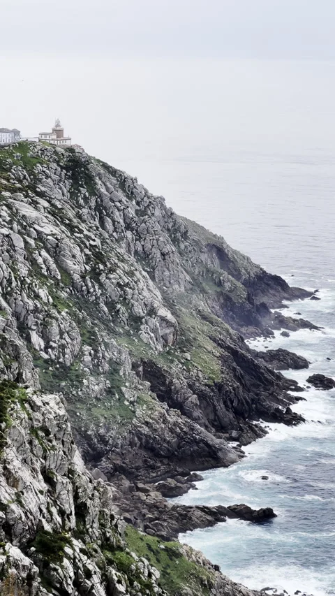 Scenic ocean cliffs and lighthouse on rocky Atlantic coastline Stock Footage 313193854