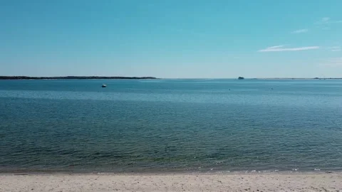 Scenic ocean view with cargo ship on the horizon Stock Footage 337690251