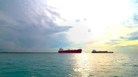 Scenic Ocean View with Cargo Vessels at Sunset. Cargo Ships and Golden Hori.. Stock Footage 304094647