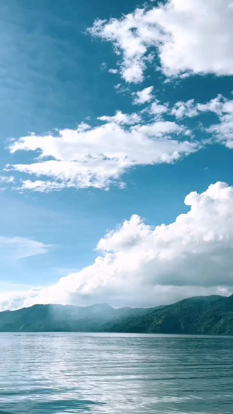 Scenic Ocean View with Fluffy Clouds and Blue Sky Stock Footage 342267735
