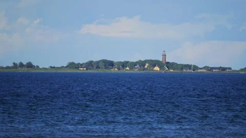 Scenic ocean view of an island with a lighthouse Stock Footage 337740420