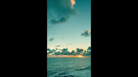 Scenic ocean view at sunrise with clouds reflecting golden light and calm s.. Stock Footage 338279913