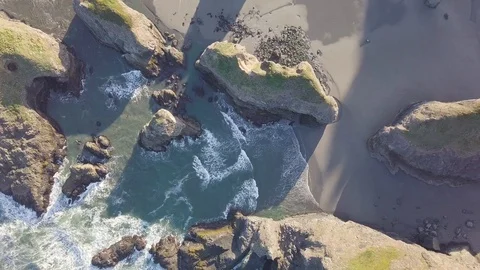 Scenic panoramic aerial drone view of flight above ocean and beach with rocks. Stock Footage 129349986