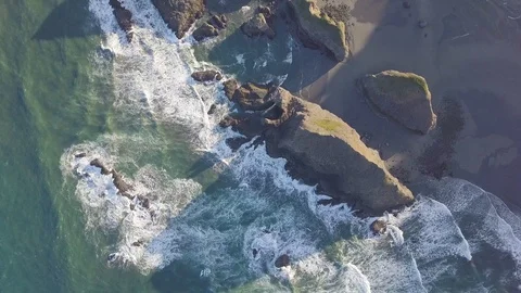 Scenic panoramic aerial drone view of flight above ocean and beach with rocks. Stock Footage 129350060