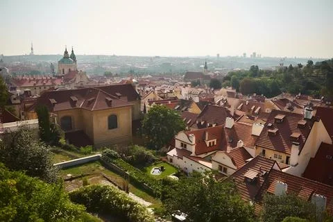 Scenic panoramic view of historic rooftops and lush greenery under bright s.. Stock Photos
