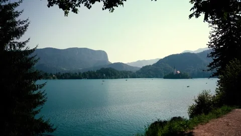 Scenic panoramic view of Lake Bled with the island church and mountains in .. Stock Footage 330585370