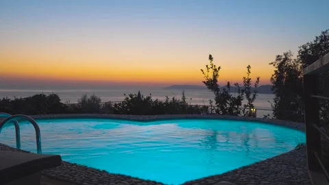Scenic Poolside Oasis Overlooking Ocean at Sunset Stock Footage 297429499