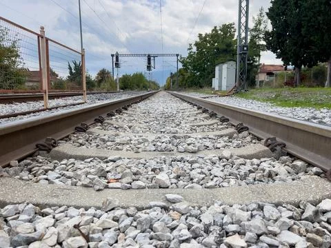Scenic rail tracks perspective view with distant horizon and overcast sky Stock Photos