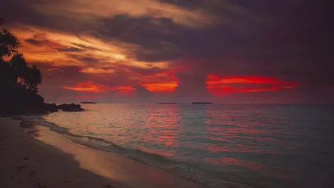 Scenic red and orange sunset at Karimunjawa Island. Tropical beach, blue sea Stock Footage 316879266