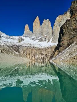 Scenic reflection of Las Torres peaks in a glacial lake, Patagonia, Chile. Stock Photos