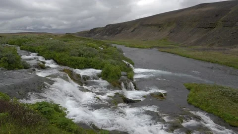 Scenic River and Cascading Waterfall in a Remote Icelandic Landscape Stock Footage 339961520