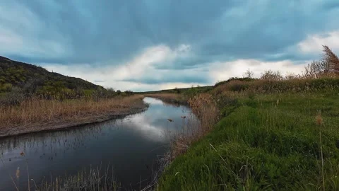 Scenic River Landscape with Dramatic Clouds at Sunset 스톡 동영상 335078148