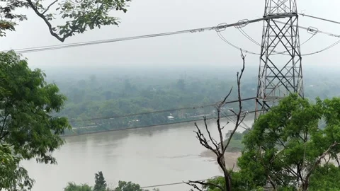 Scenic river landscape with forest and power transmission tower Vídeo Stock 337926742